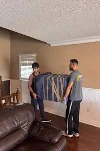 Professional movers relocating leather furniture in Toronto home