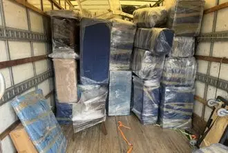 BMOVED moving truck loaded with wrapped furniture and boxes organized for safe transport