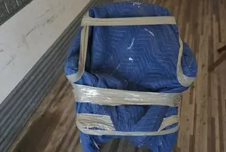 Furniture wrapped in blue protective blankets by BMOVED professional movers